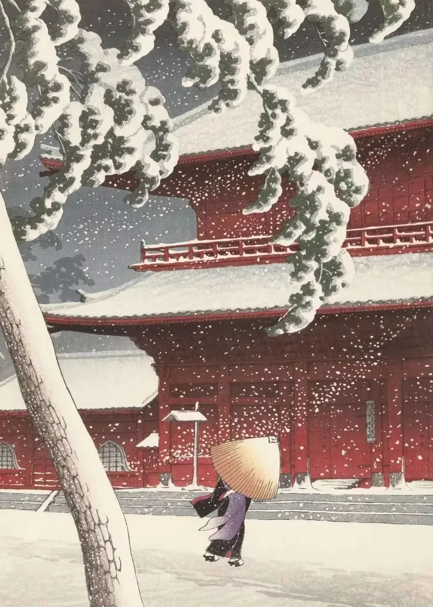 Traditional Japanese architecture with a person holding a straw hat during snowfall