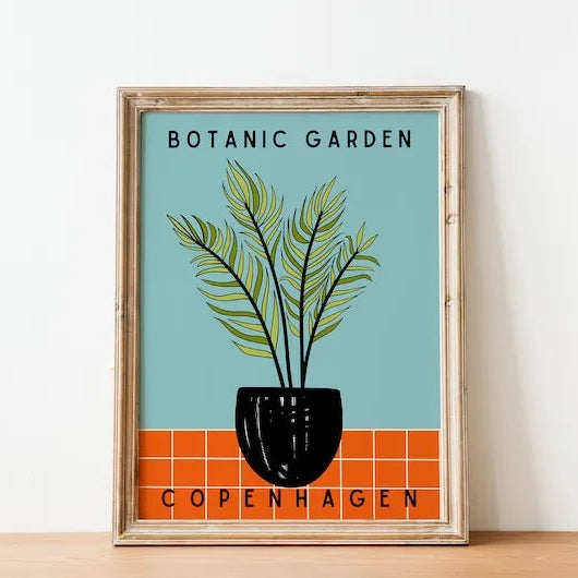 Framed poster of a plant design with 'Botanic Garden Copenhagen' text on a light blue background.