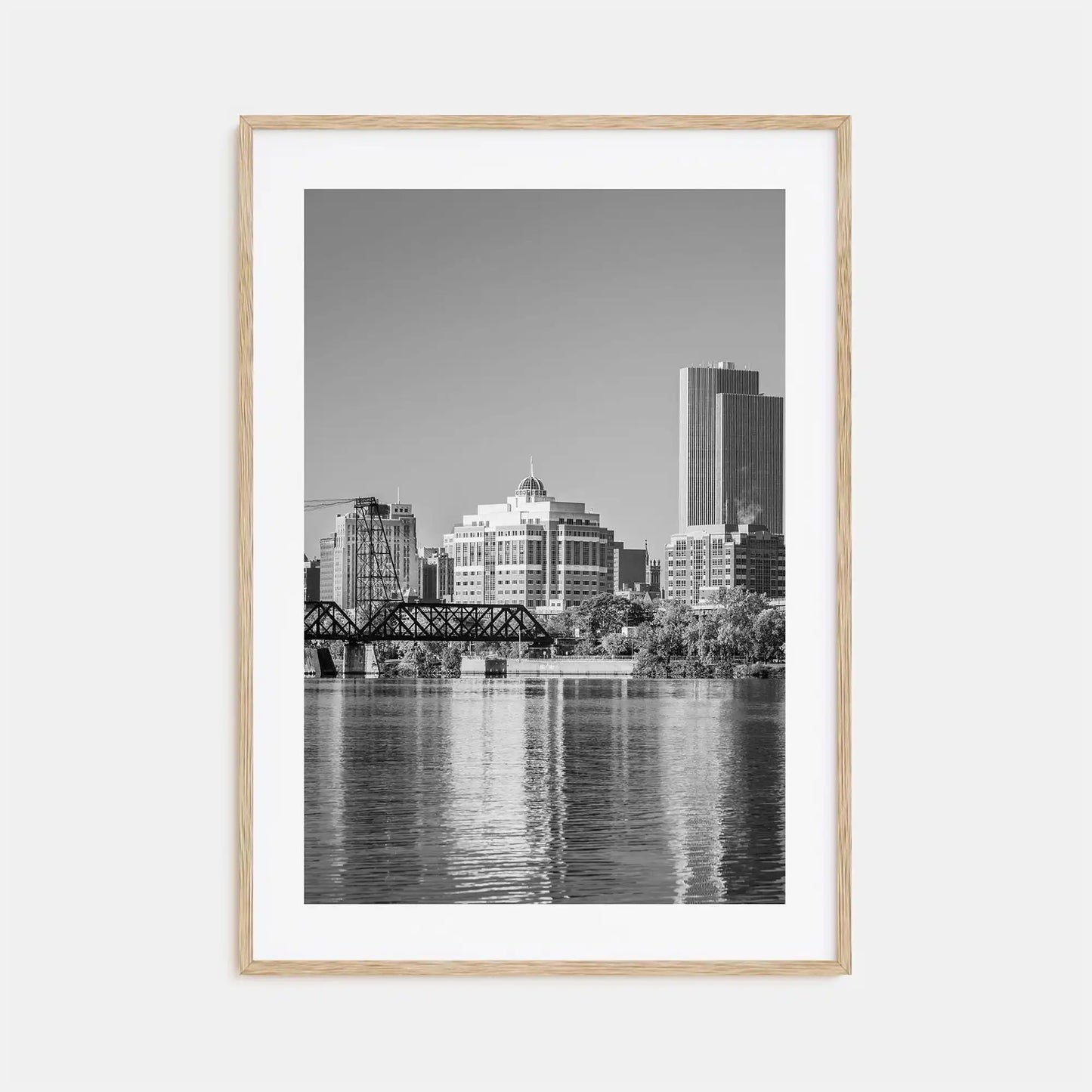 Framed black and white cityscape print with a river and skyline.