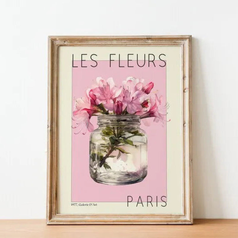 Framed artwork with 'Les Fleurs Paris' text and pink flowers in a jar on a light background