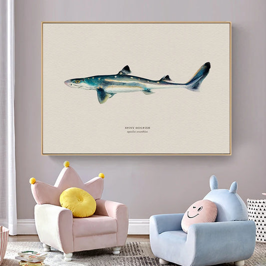 Framed artwork of a shark on a wall above two children's chairs with colorful cushions. Canvas & Curio