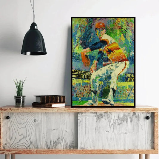 Colorful abstract painting of a baseball player on a wooden console table with a black pendant light. Canvas & Curio