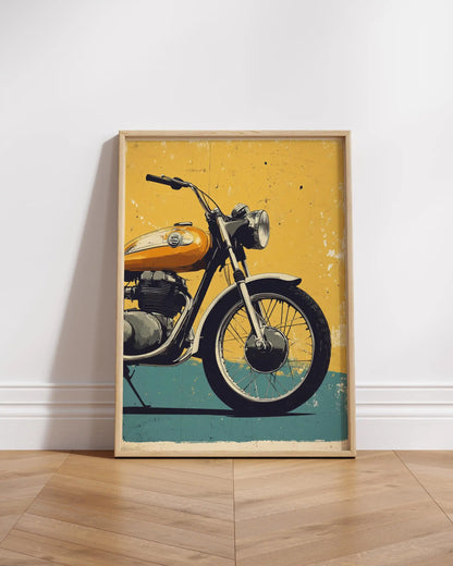 Framed poster of a vintage motorcycle on a wooden floor with a white wall background