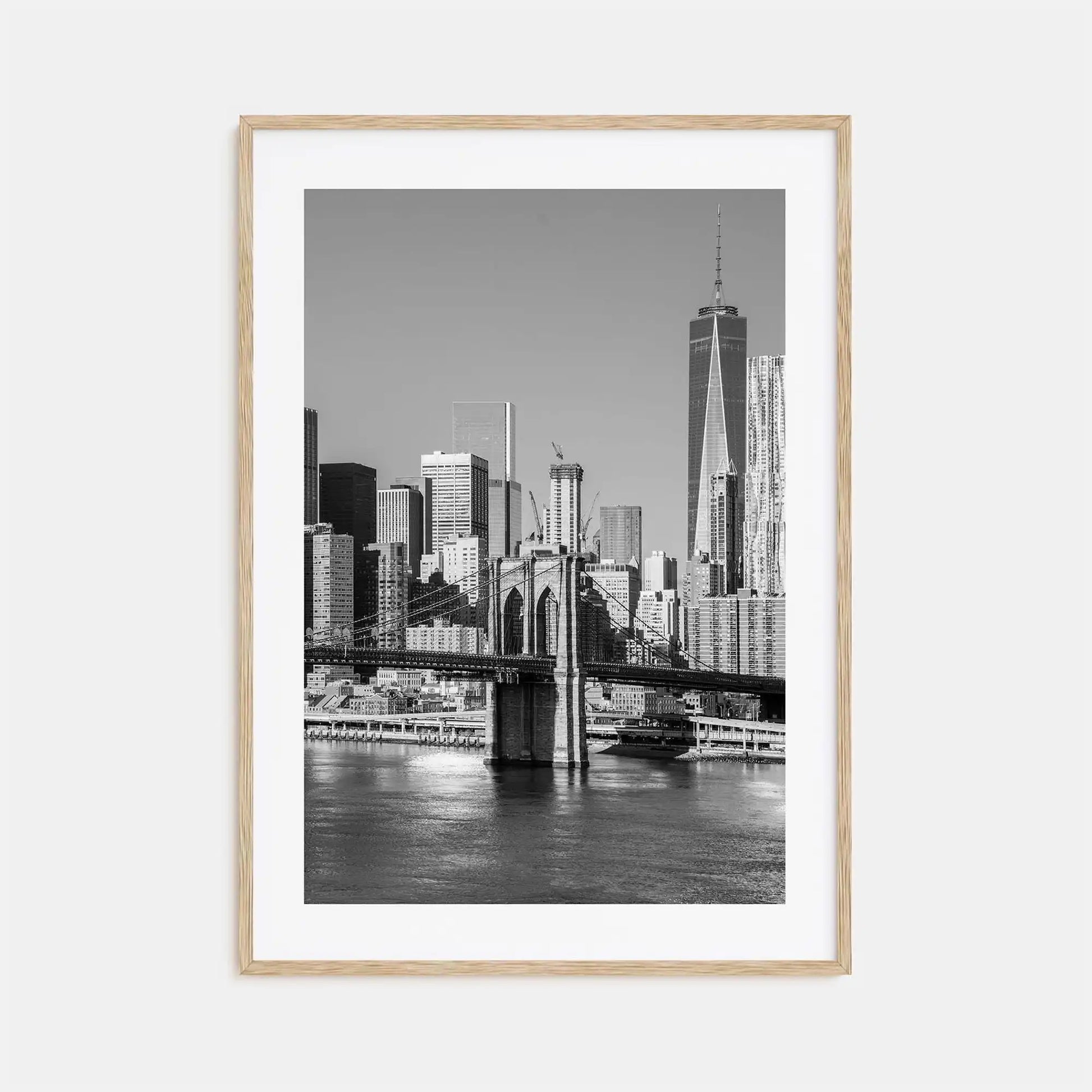 Framed black and white cityscape print of a skyline with a river and bridge.