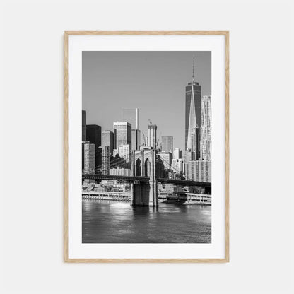 Framed black and white cityscape print of a skyline with a river and bridge.