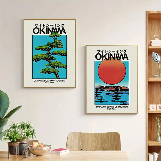 Two framed posters of Okinawa on a wall above a dining table with plants and books. Canvas & Curio