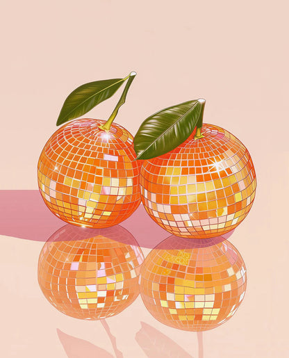 Two disco balls with reflective orange surface and green leaves on a pink background