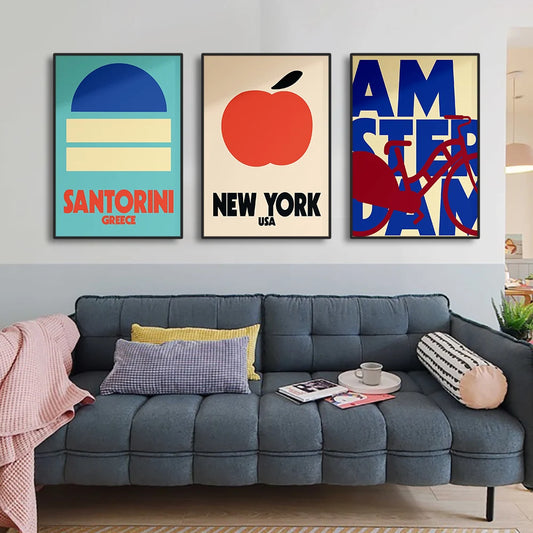 Gray sectional sofa with decorative pillows in a living room setting, featuring three colorful wall posters. Canvas & Curio
