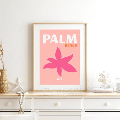 Framed artwork with 'Palm Beach USA' design on a wall above a white cabinet.