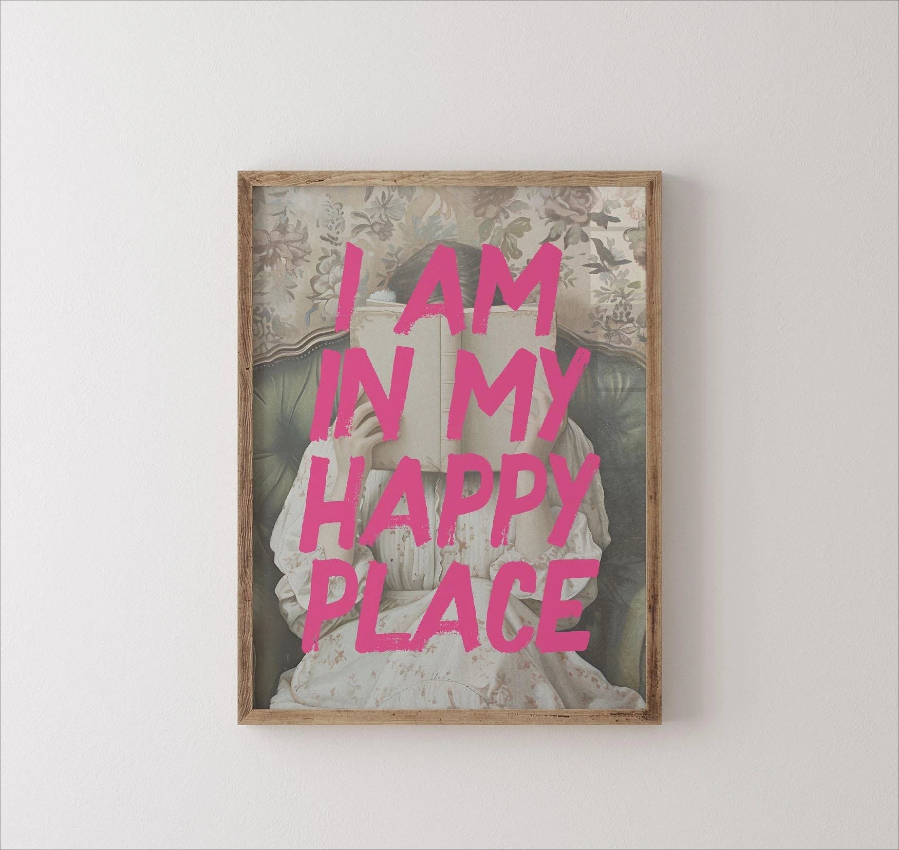 Framed artwork with 'I am in my happy place' text on a white wall