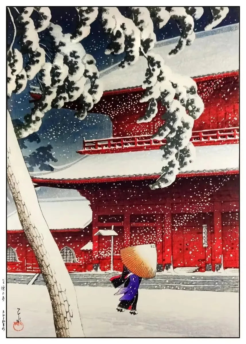 Traditional Japanese red temple gate with a person holding an umbrella during snowfall