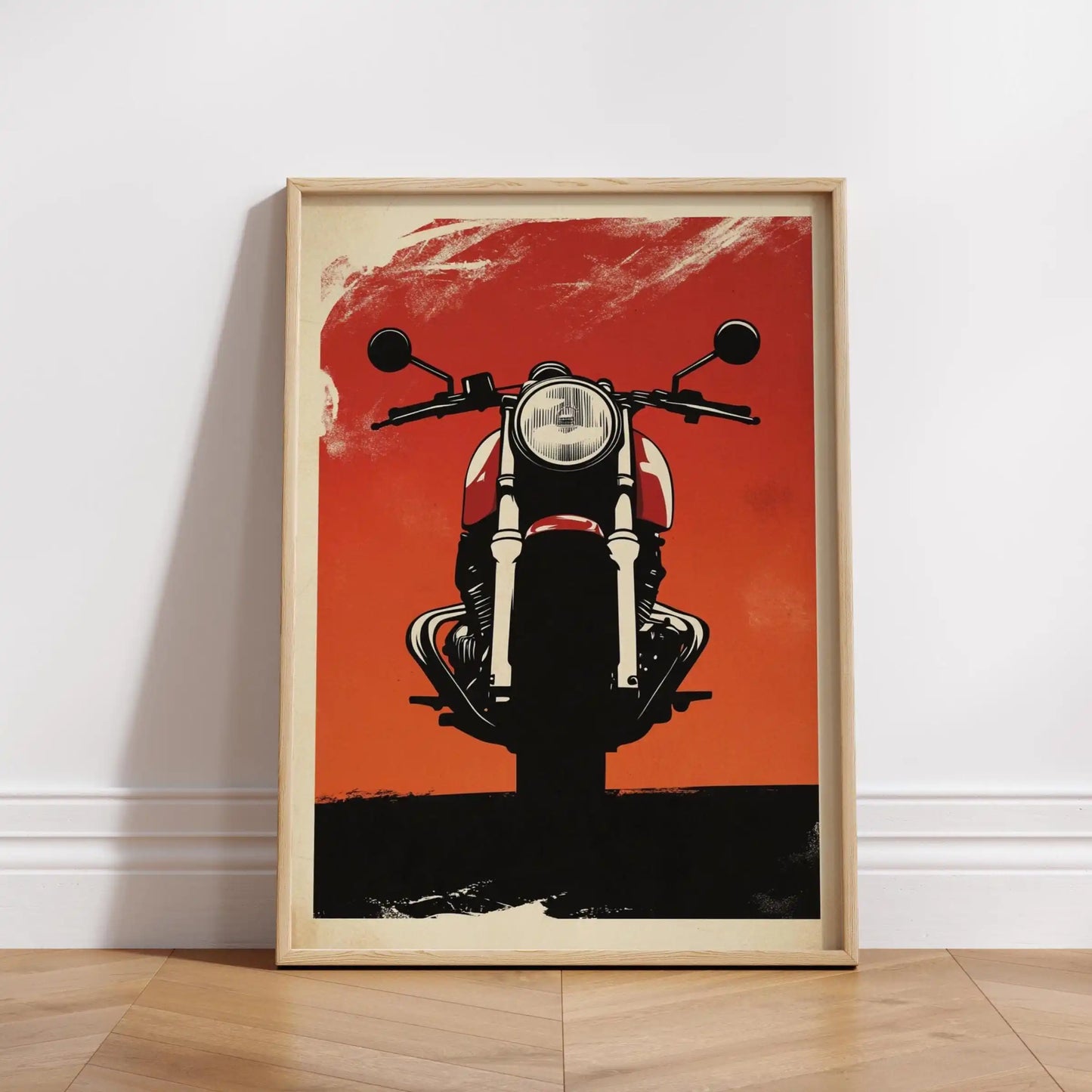 Framed poster of a motorcycle on an orange background, leaning against a white wall.