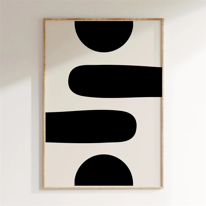 Abstract art print with black shapes on a beige background, framed in gold.