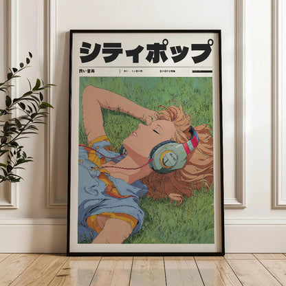 Framed poster of a person lying on grass with headphones, leaning against a wall.