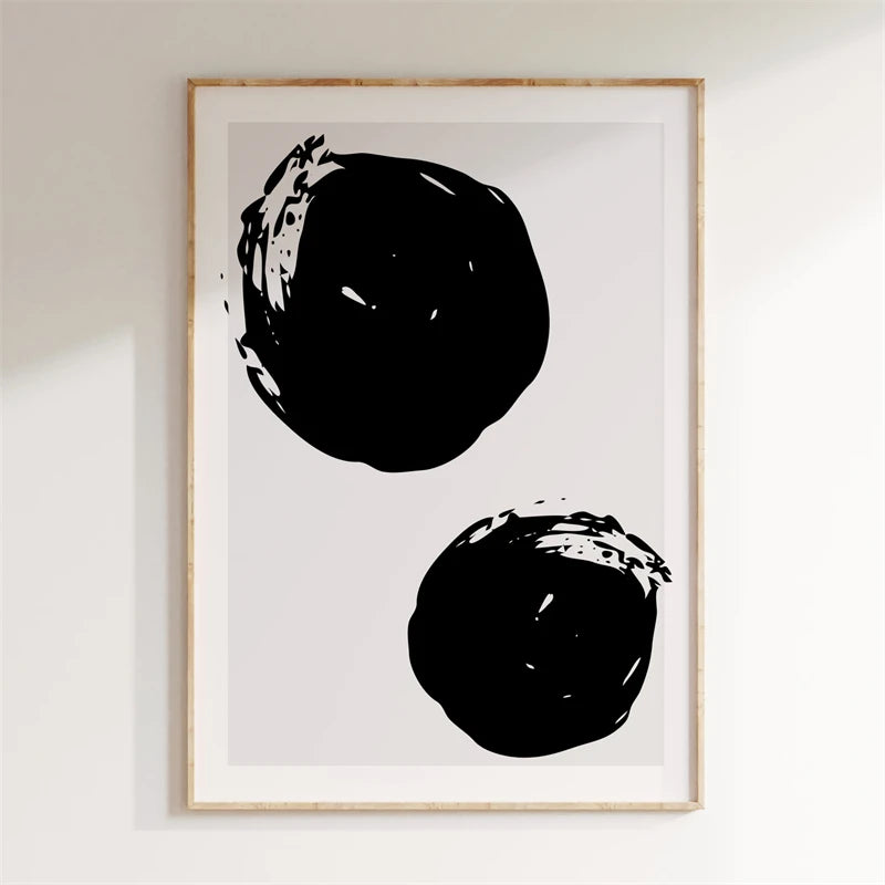 Framed artwork with two black abstract shapes on a white background