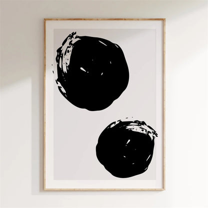 Framed artwork with two black abstract shapes on a white background