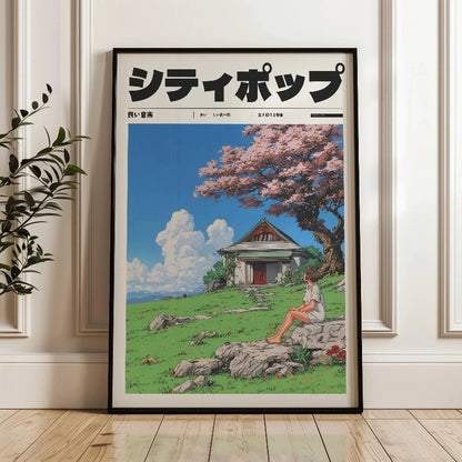 Framed artwork of a person sitting under a cherry blossom tree with a traditional building in the background.