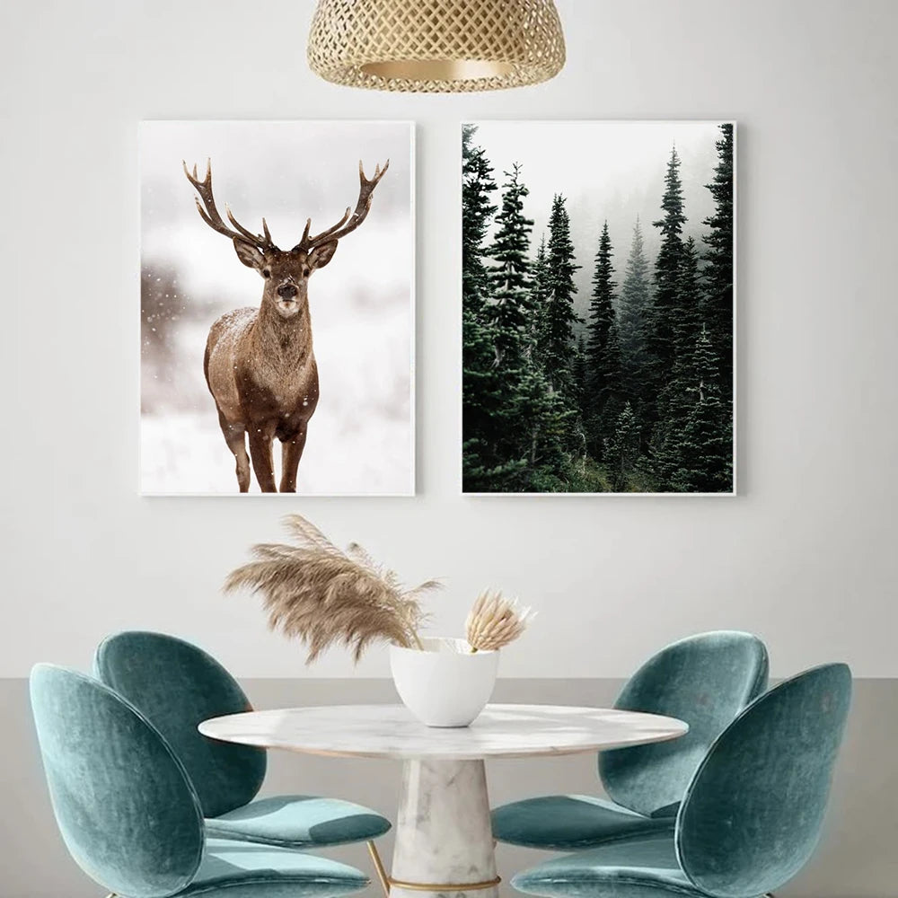 Two framed artworks of a deer and forest on a wall above a round table with chairs.