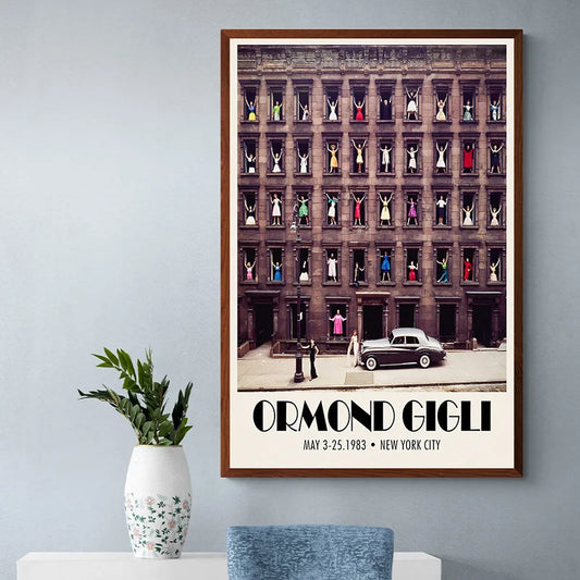 Framed poster of a building with people in windows and 'Ormond Gigli' text on a wall. Canvas & Curio