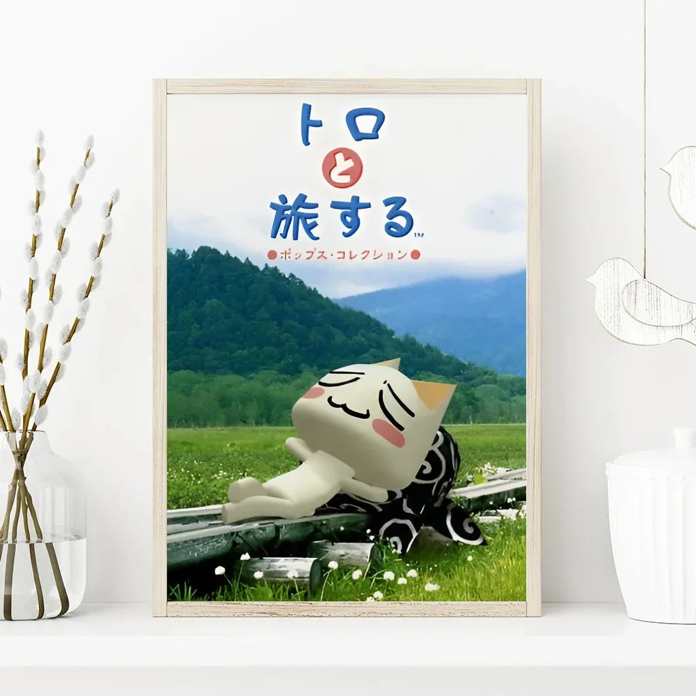 Framed artwork with a cat-like character lying on grass and mountains in the background