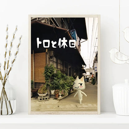 Framed picture of a cat-like character on a street with Japanese text above