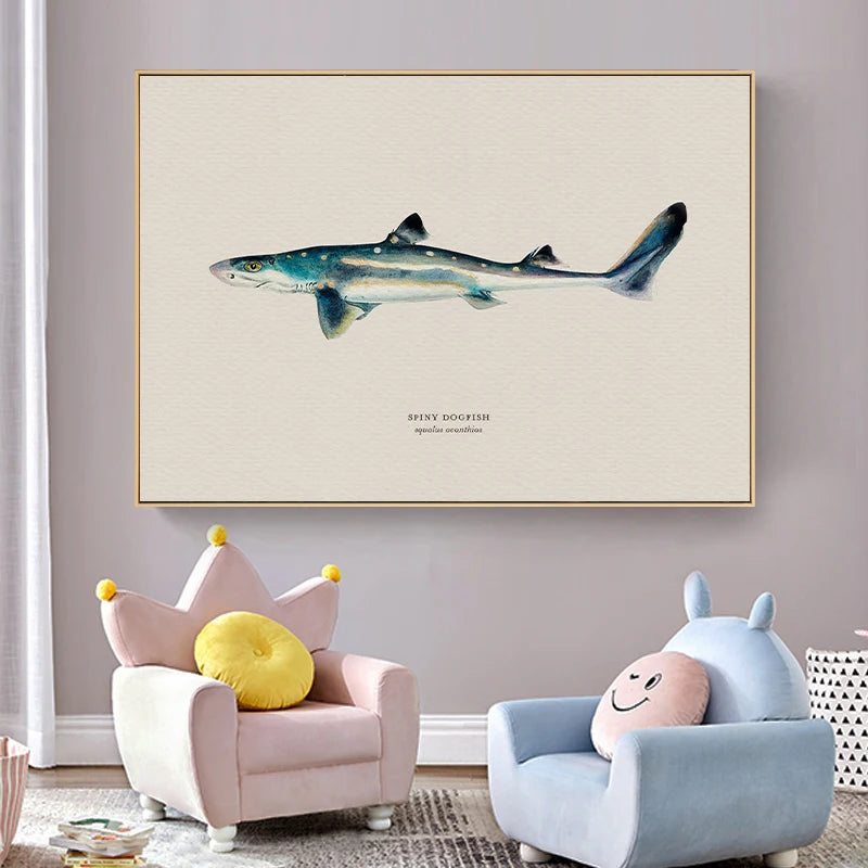 Framed artwork of a shark on a wall above two children's chairs with colorful cushions.