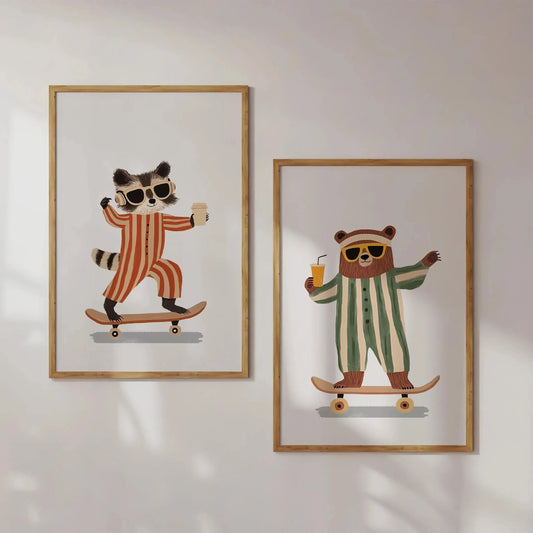 Two framed illustrations of a raccoon and a bear on skateboards with sunglasses and drinks, on a white wall. Canvas & Curio
