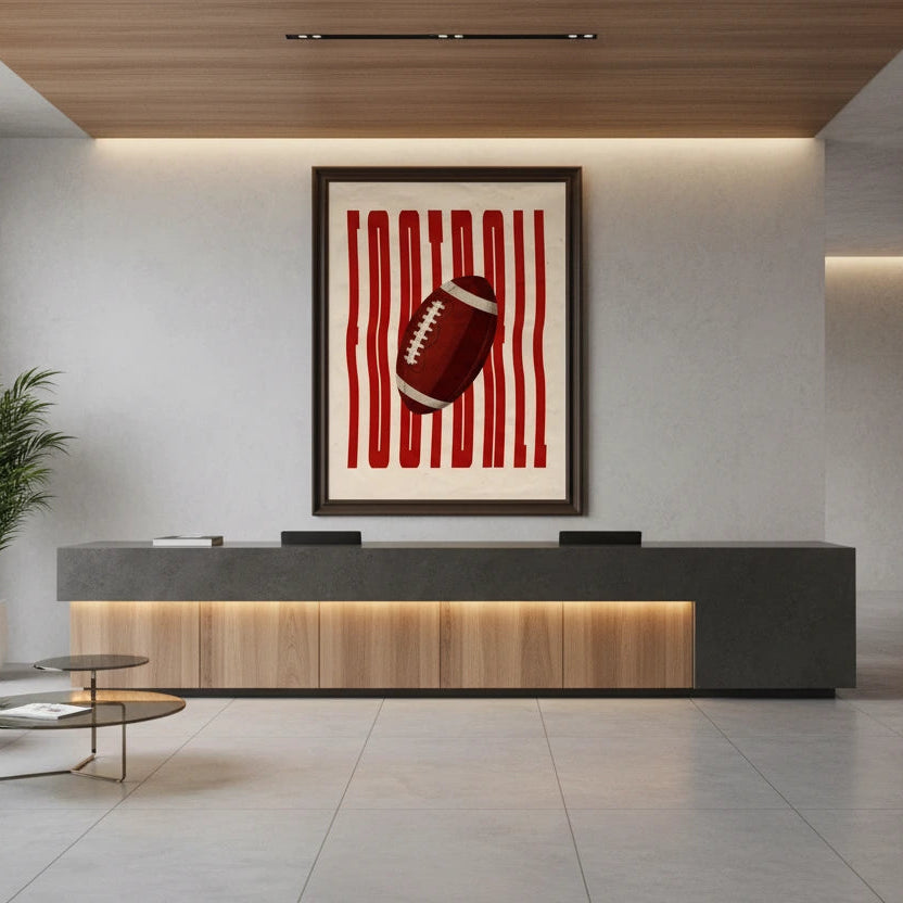 Modern office lobby with reception desk, chairs, and a decorative football artwork on the wall.