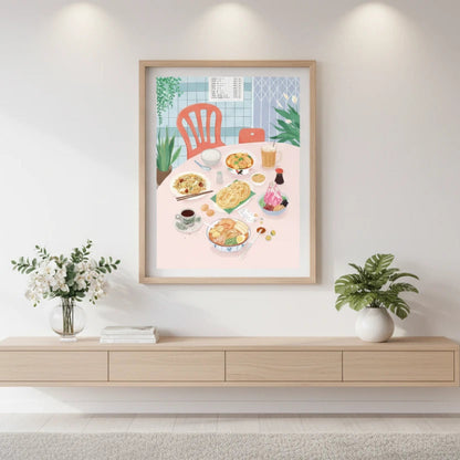 Framed artwork of a dining scene on a wall above a wooden console table.