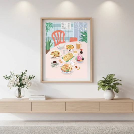 Framed artwork of a dining scene on a wall above a wooden console table. Canvas & Curio